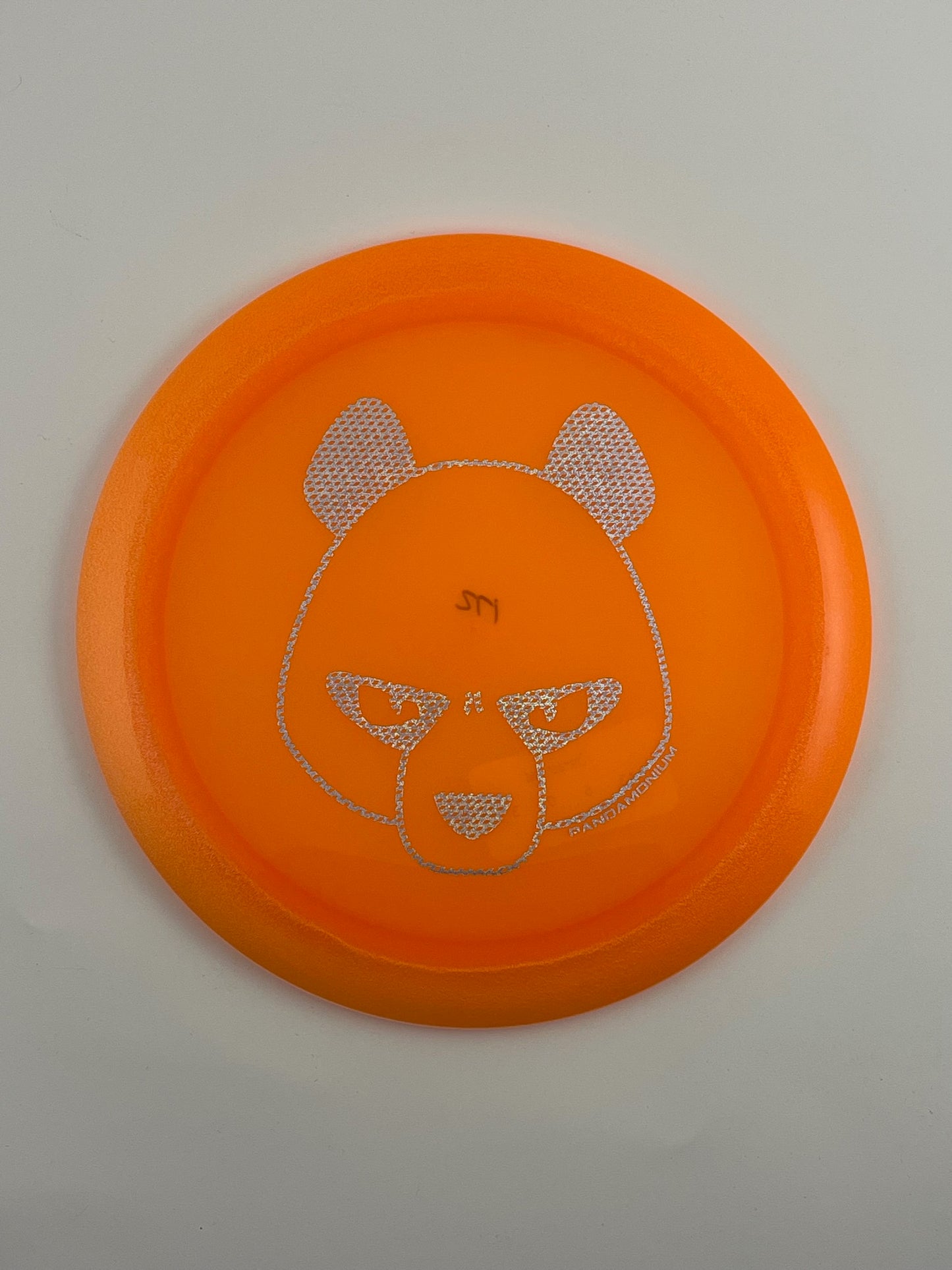 Innova Boss disc golf distance driver in orange Champion plastic with Pandamonium Big Panda stamp