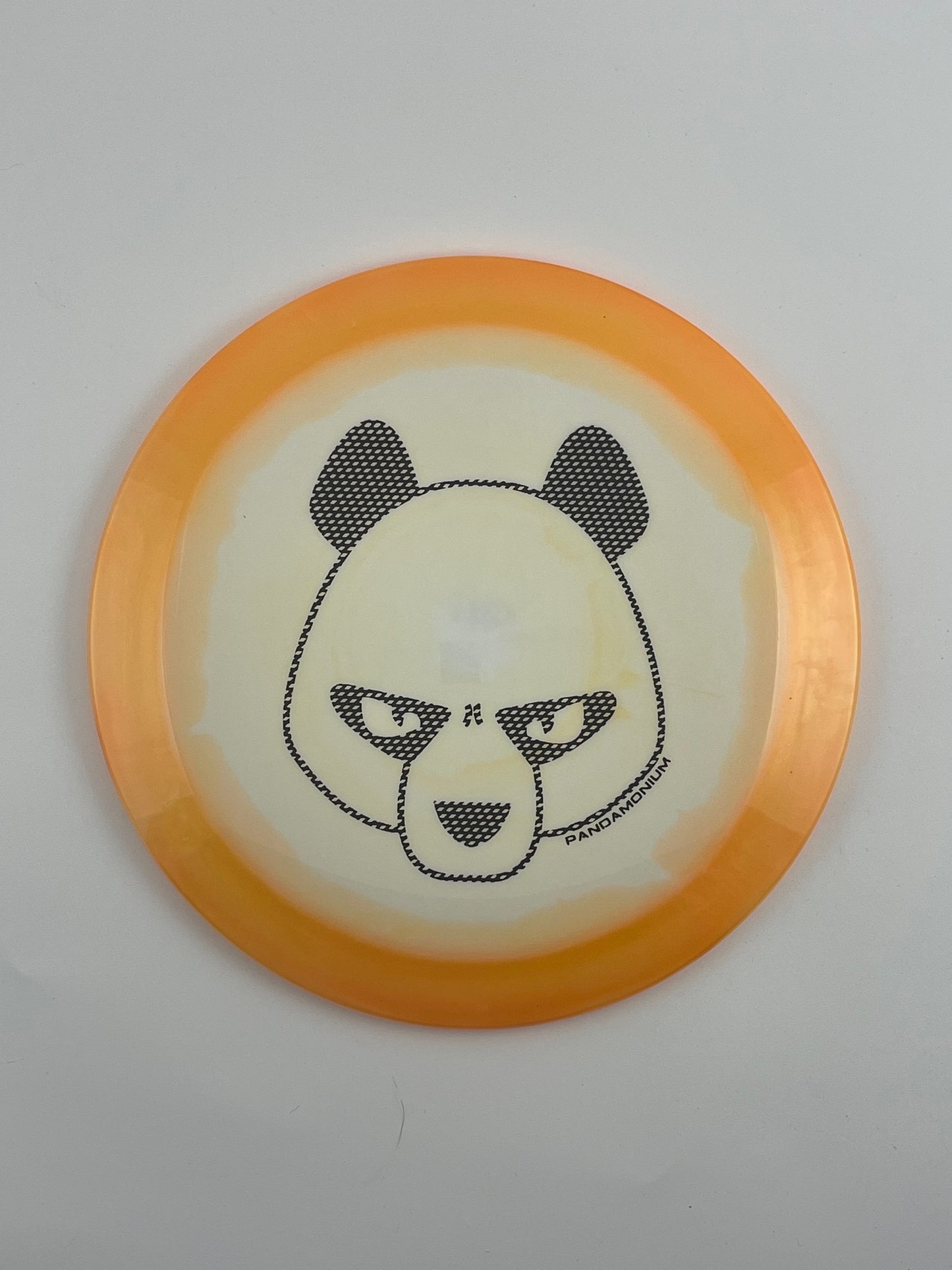 Innova Shryke disc golf distance driver in orange and white Halo Star plastic with Pandamonium Big Panda stamp