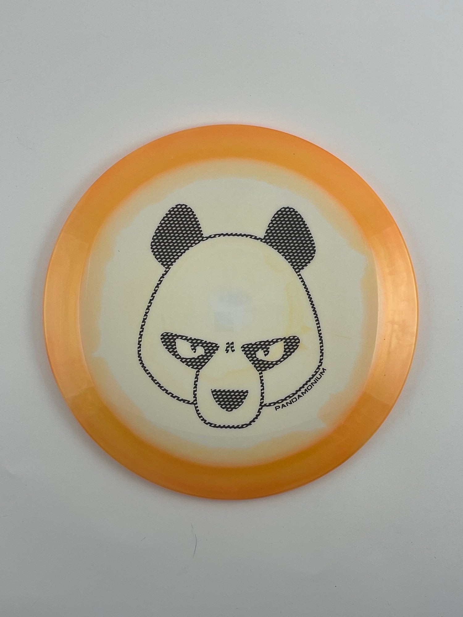 Innova Shryke disc golf distance driver in orange and white Halo Star plastic with Pandamonium Big Panda stamp
