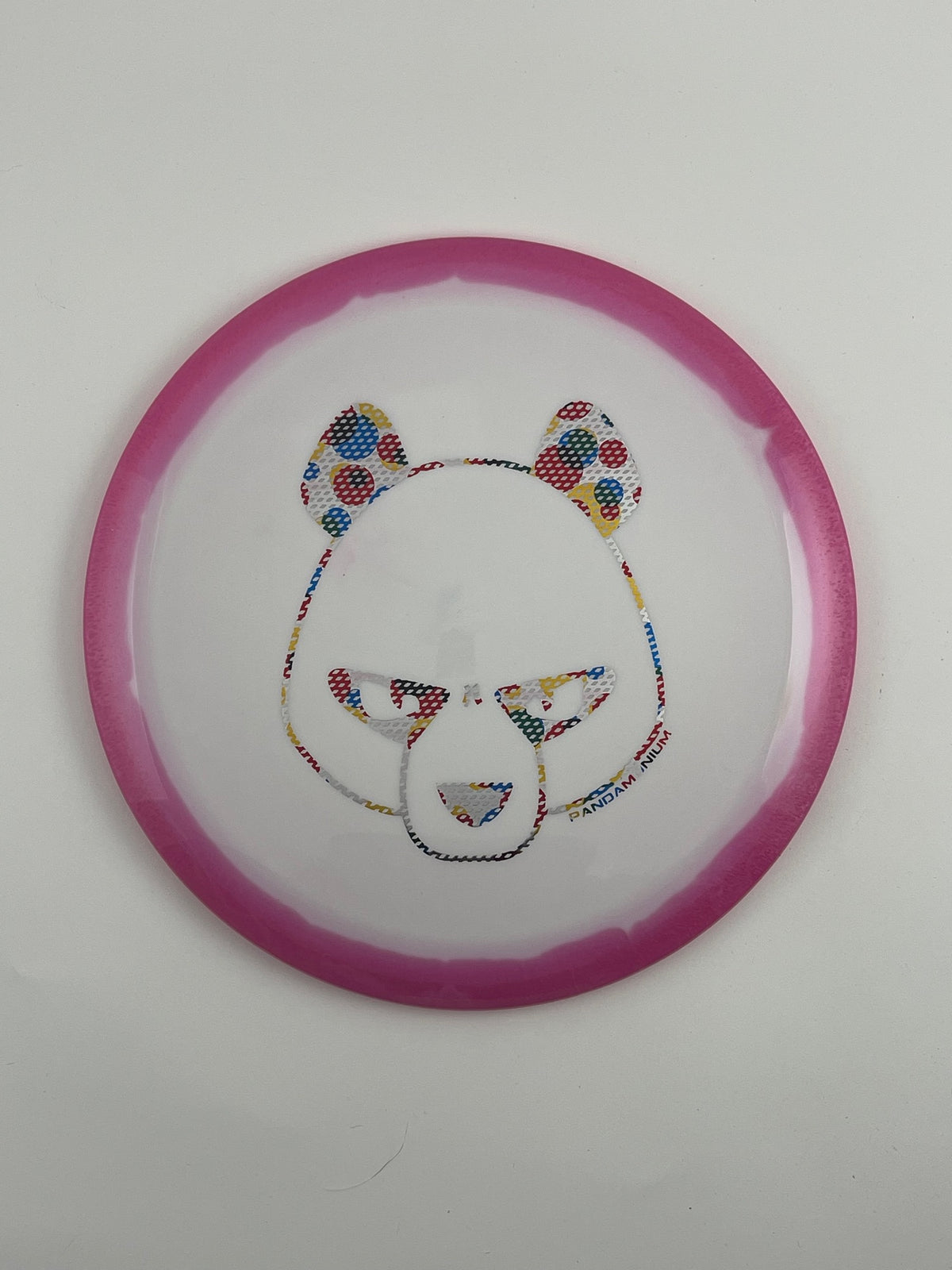 Innova Wraith disc golf distance driver in magenta and white Halo Star plastic with Pandamonium Big Panda stamp