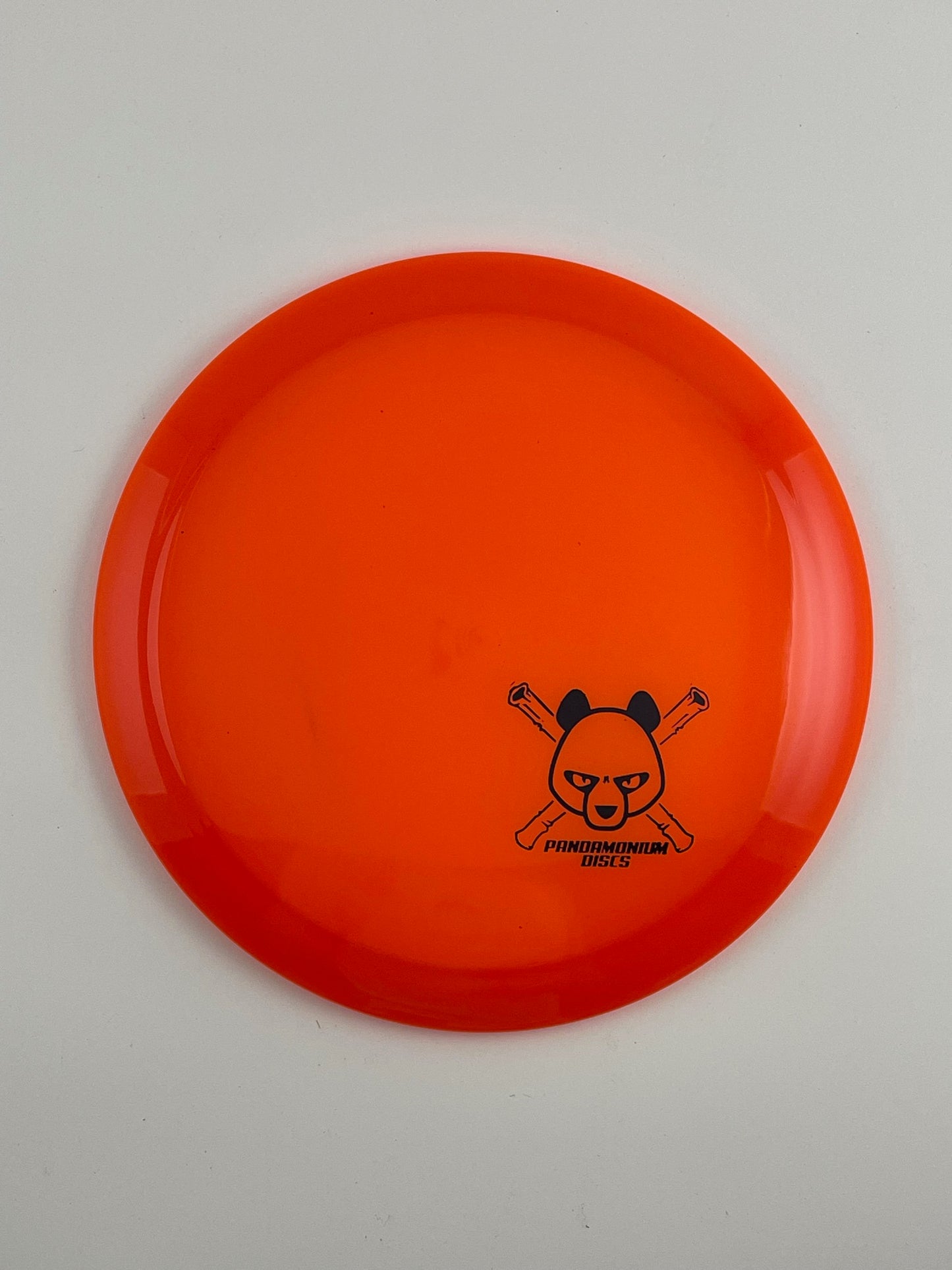 Latitude 64 Diamond disc golf fairway driver in orange Opto plastic with Pandamonium Panda Corner X stamp