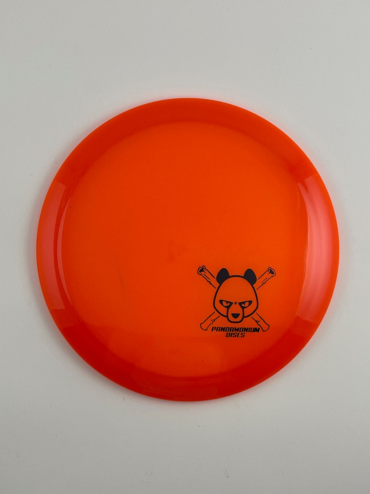 Latitude 64 Diamond disc golf fairway driver in orange Opto plastic with Pandamonium Panda Corner X stamp
