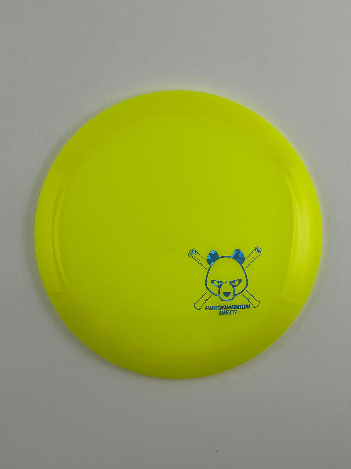 Latitude 64 Diamond disc golf fairway driver in yellow Opto plastic with Pandamonium Panda Corner X stamp