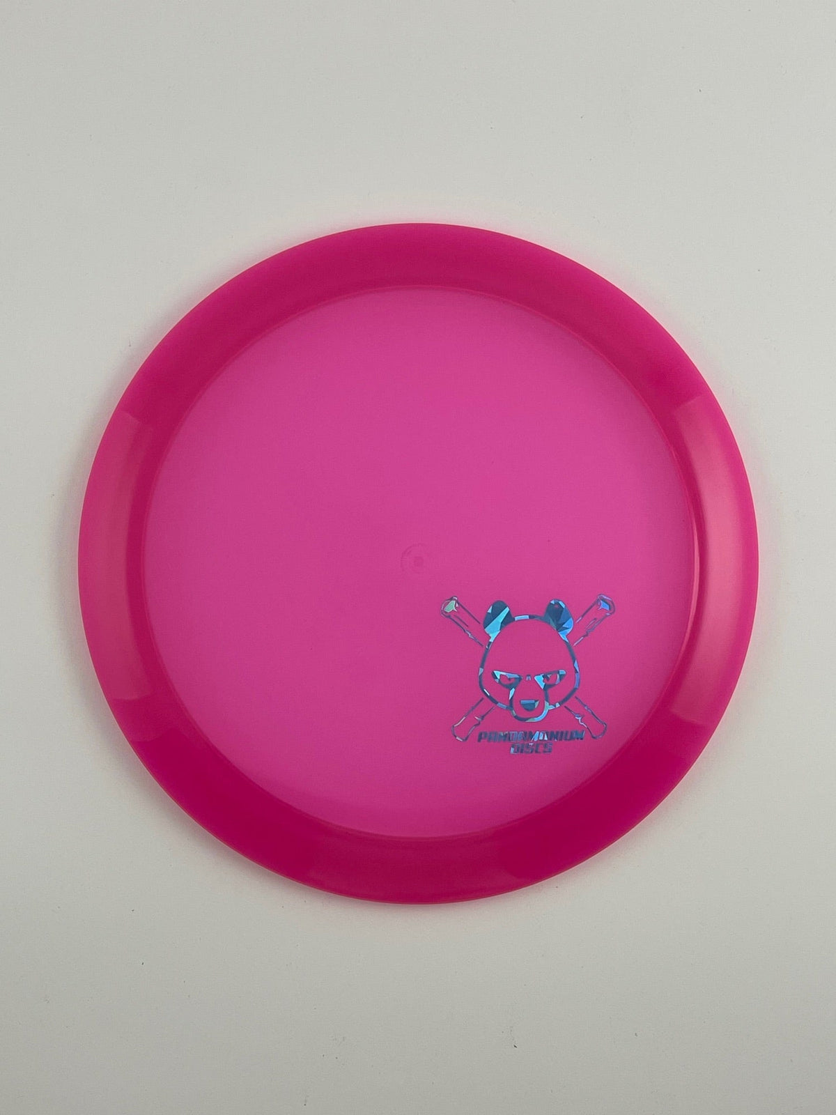 Latitude 64 Sapphire disc golf distance driver in pink Opto plastic with Pandamonium Panda Corner X stamp