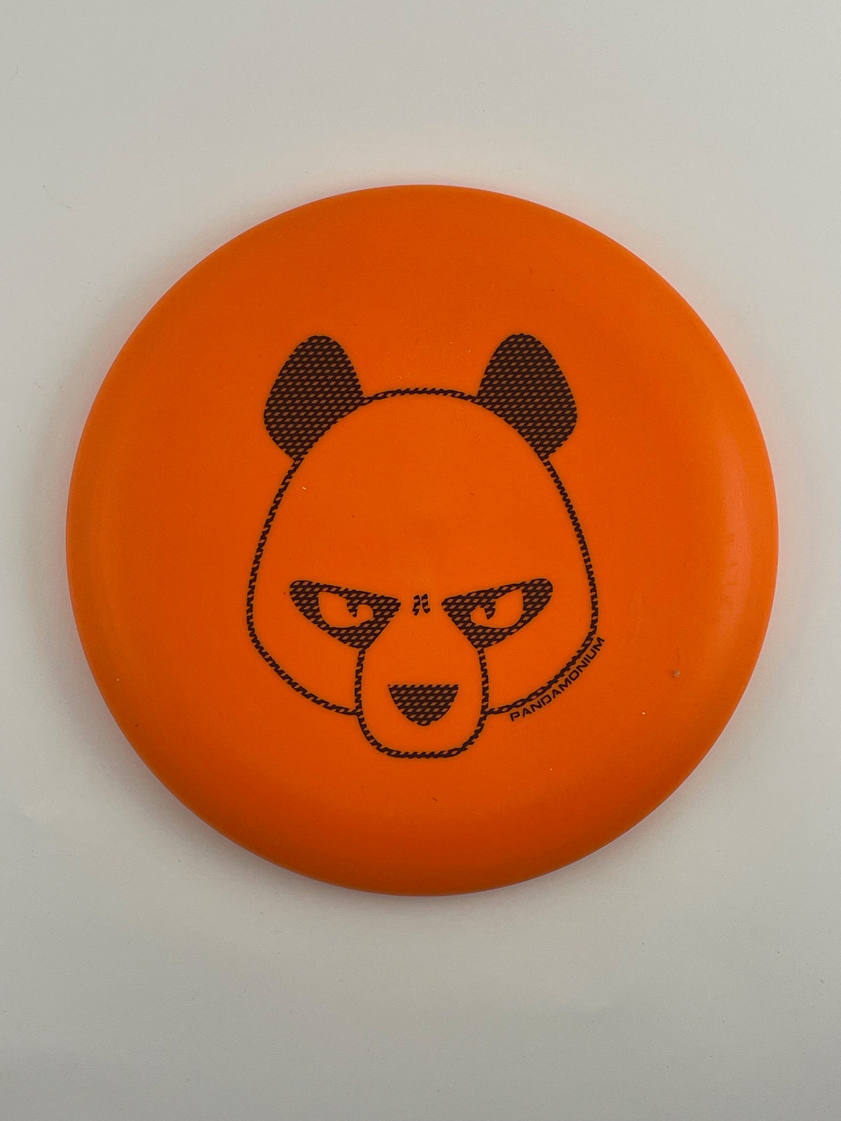 Innova Pig disc golf putt and approach in orange R-Pro plastic with Pandamonium Big Panda stamp, view 2