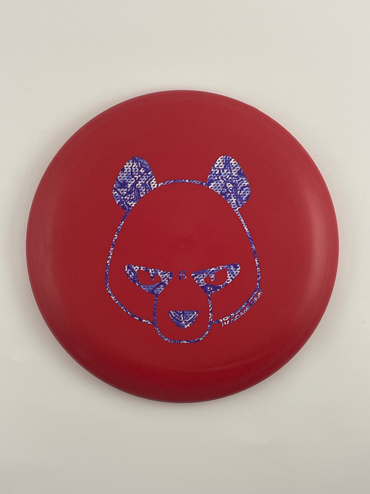 Innova Pig disc golf putt and approach in red R-Pro plastic with Pandamonium Big Panda stamp, view 2