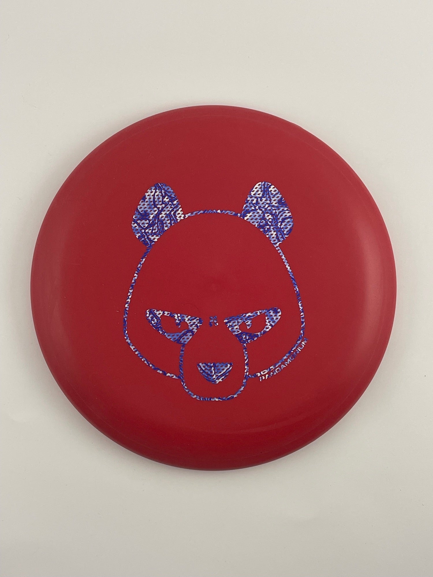 Innova Pig disc golf putt and approach in red R-Pro plastic with Pandamonium Big Panda stamp, view 2