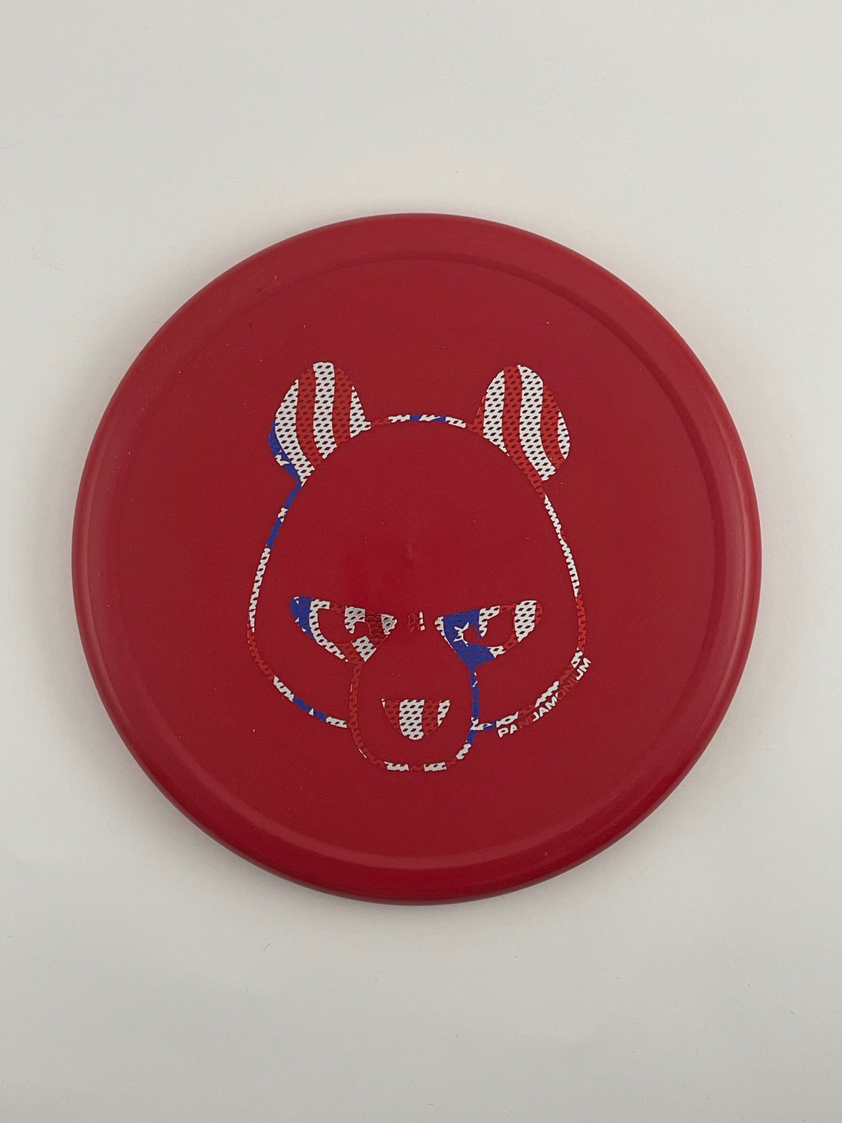 Innova Pig disc golf putt and approach in red R-Pro plastic with Pandamonium Big Panda stamp, view 1